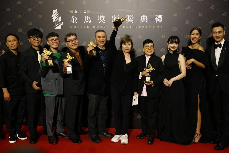 Director Chen Yu-hsun and others pose with the Best Narrative Feature award for "My Missing Valentine" at the 57th Golden Horse Awards in Taipei, Taiwan November 21, 2020. REUTERS/Ann Wang